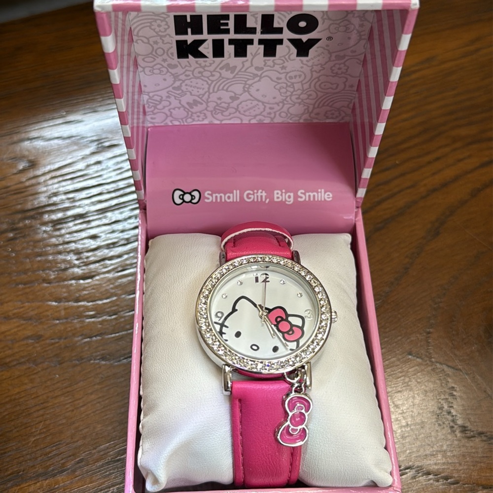 - New Hello Kitty Pink Watch with Charm. Rhinestones around dial.  Kitty o…